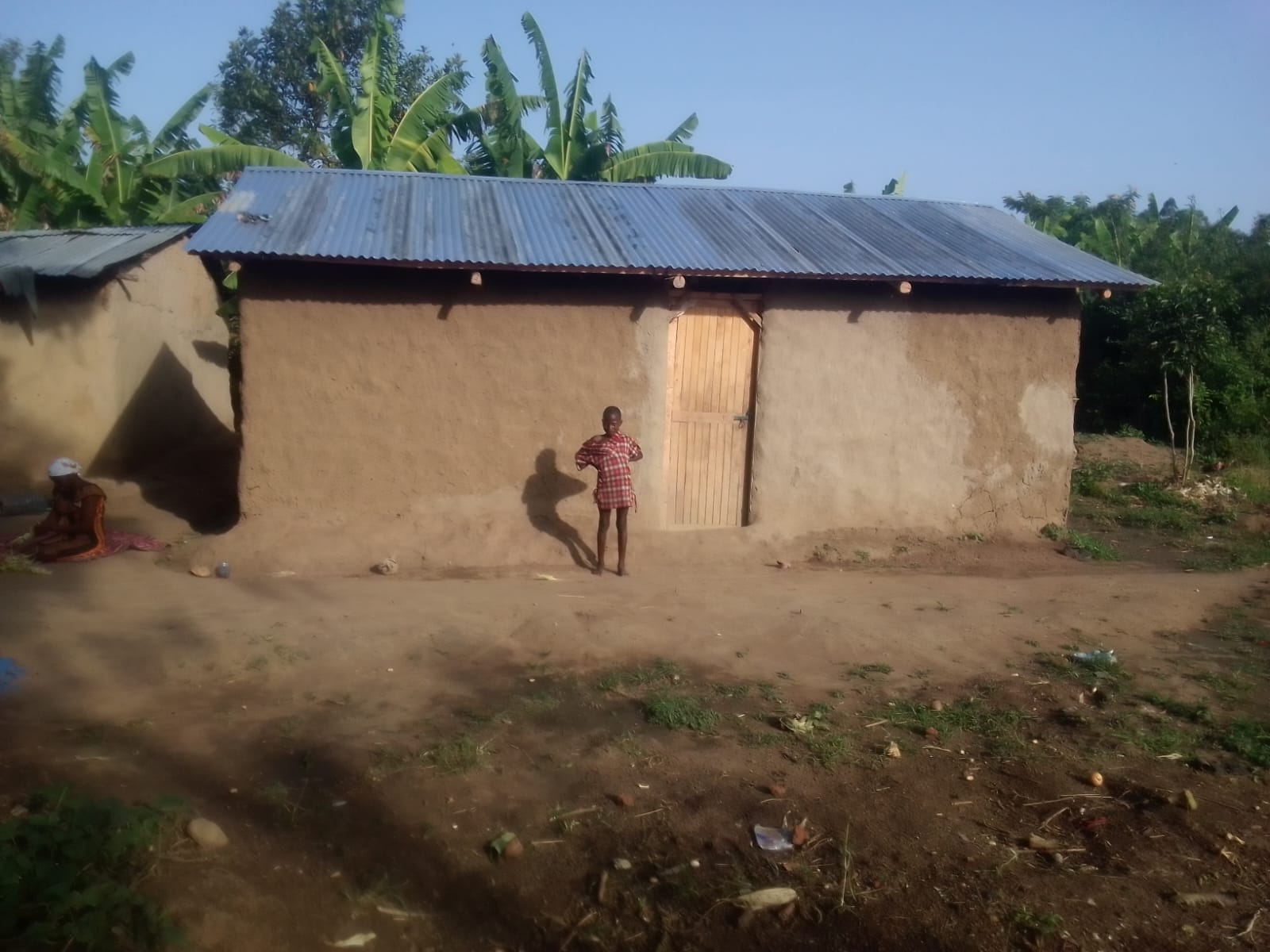 Widow's new home after reconstruction, with family
