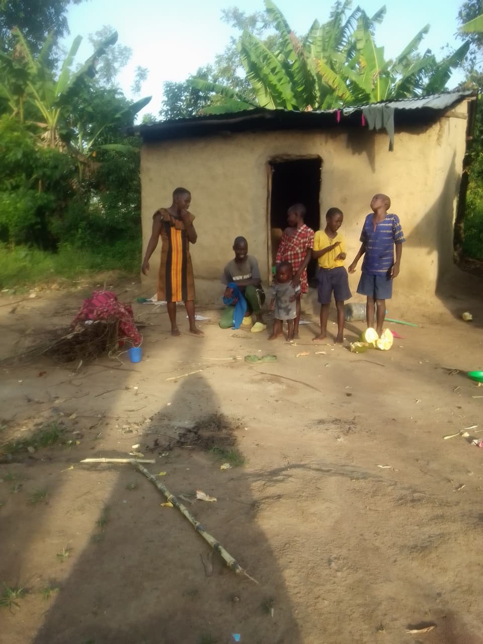 The widow with her children outside the old house